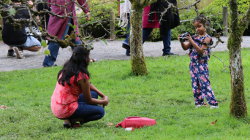 Little Girl Taking Photo of Mom